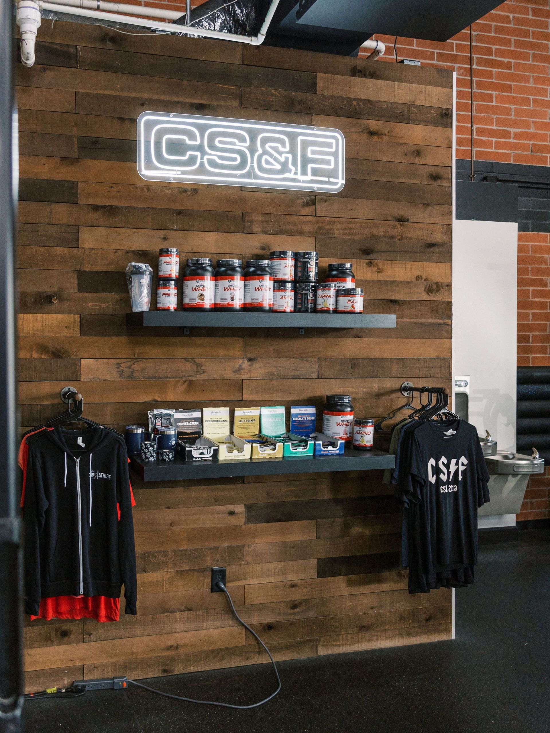 A wall with a sign that says cs & f on it