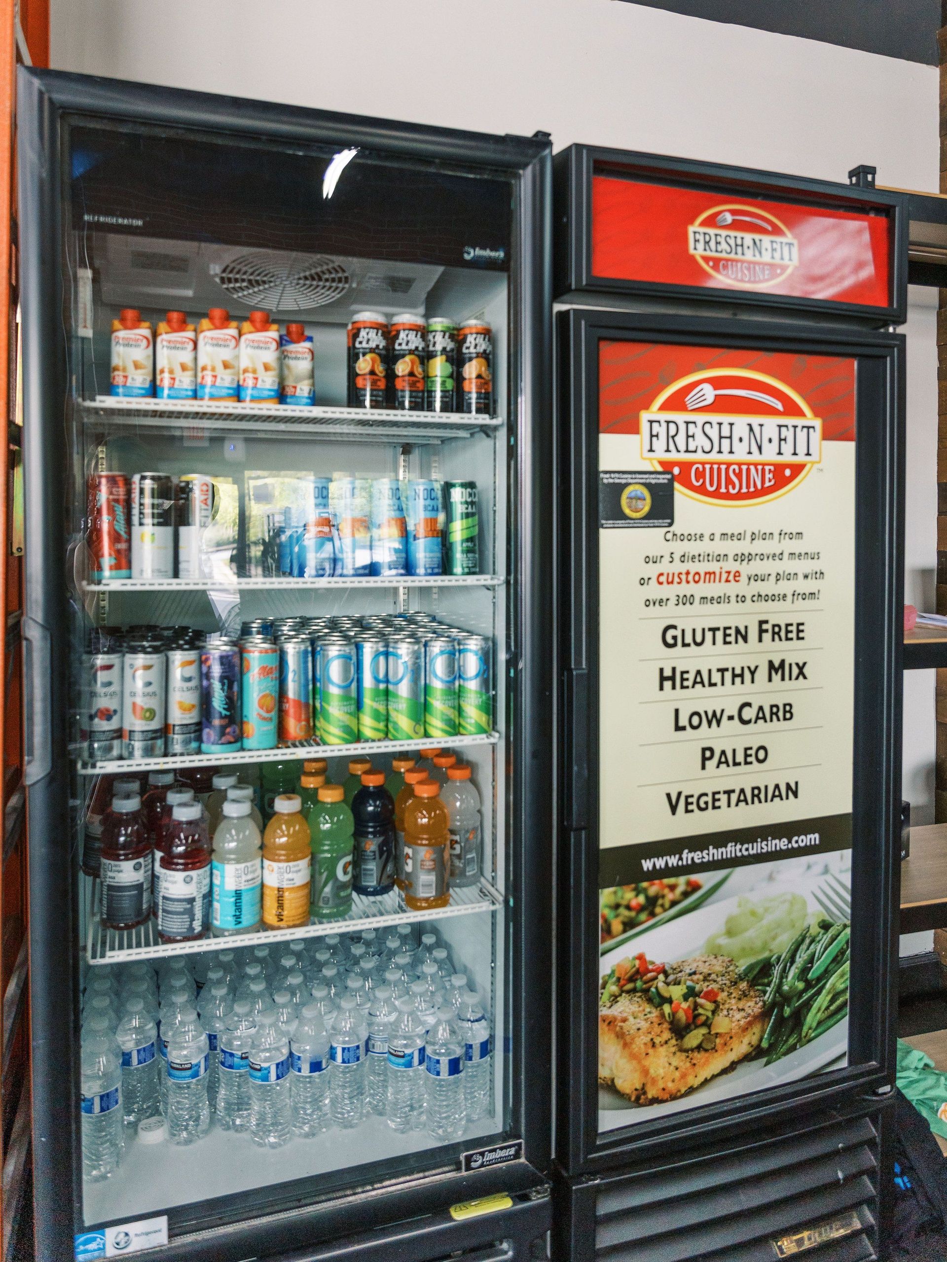 A refrigerator filled with bottles and cans of soda.