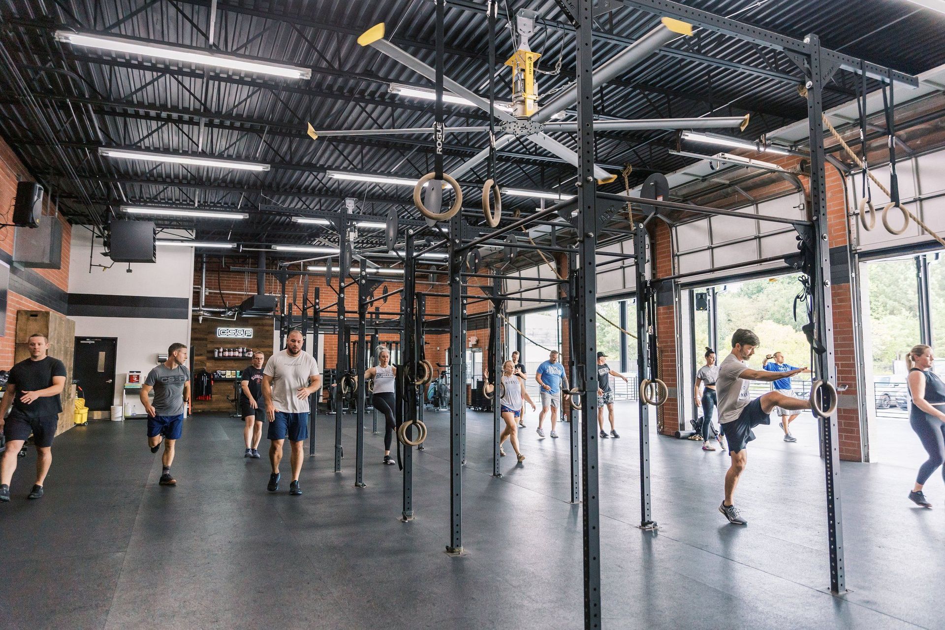 A group of people are doing exercises in a gym.