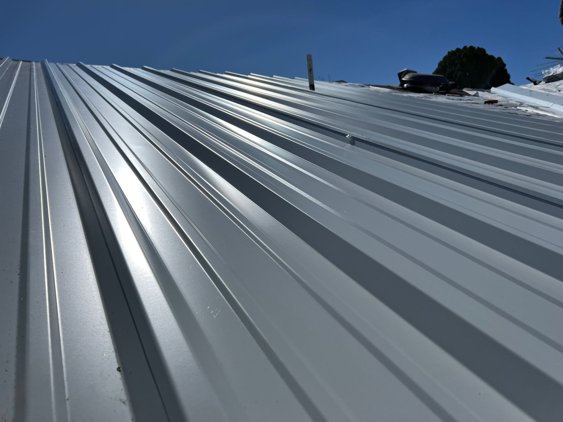 A metal roof with a blue sky in the background