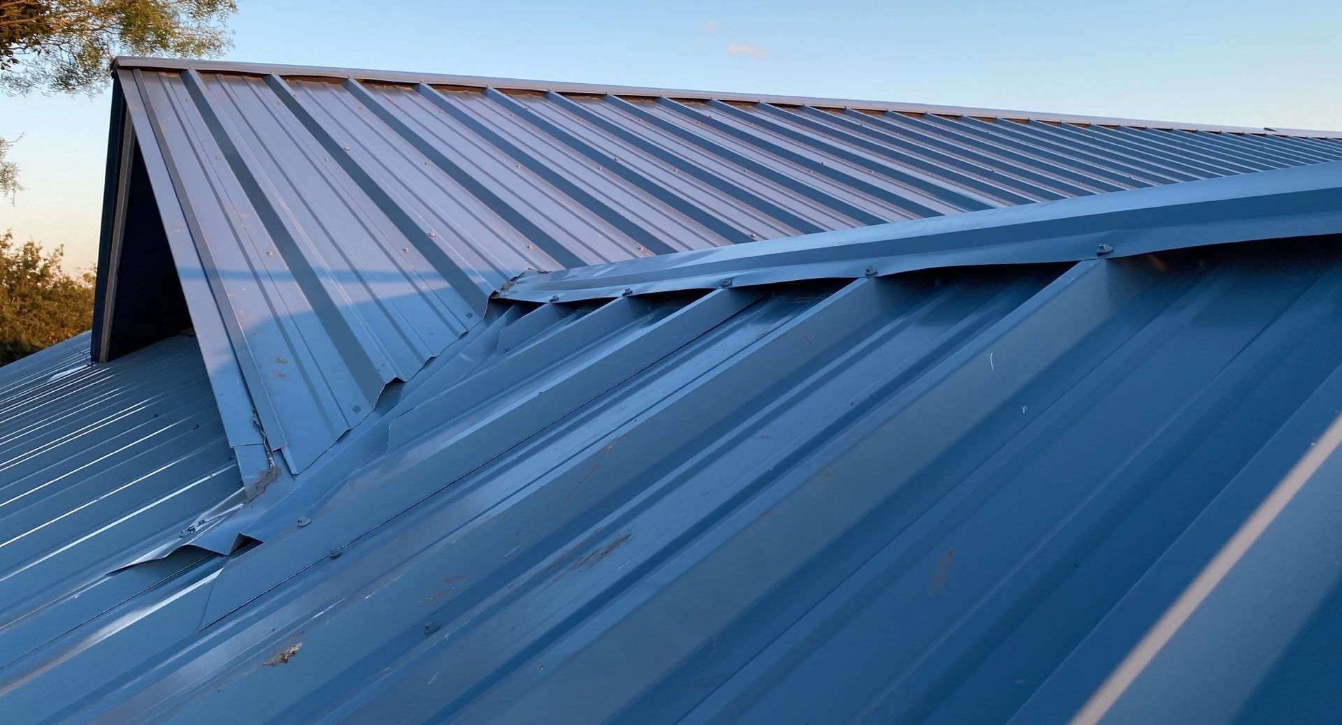 A blue metal roof is sitting on top of a building.