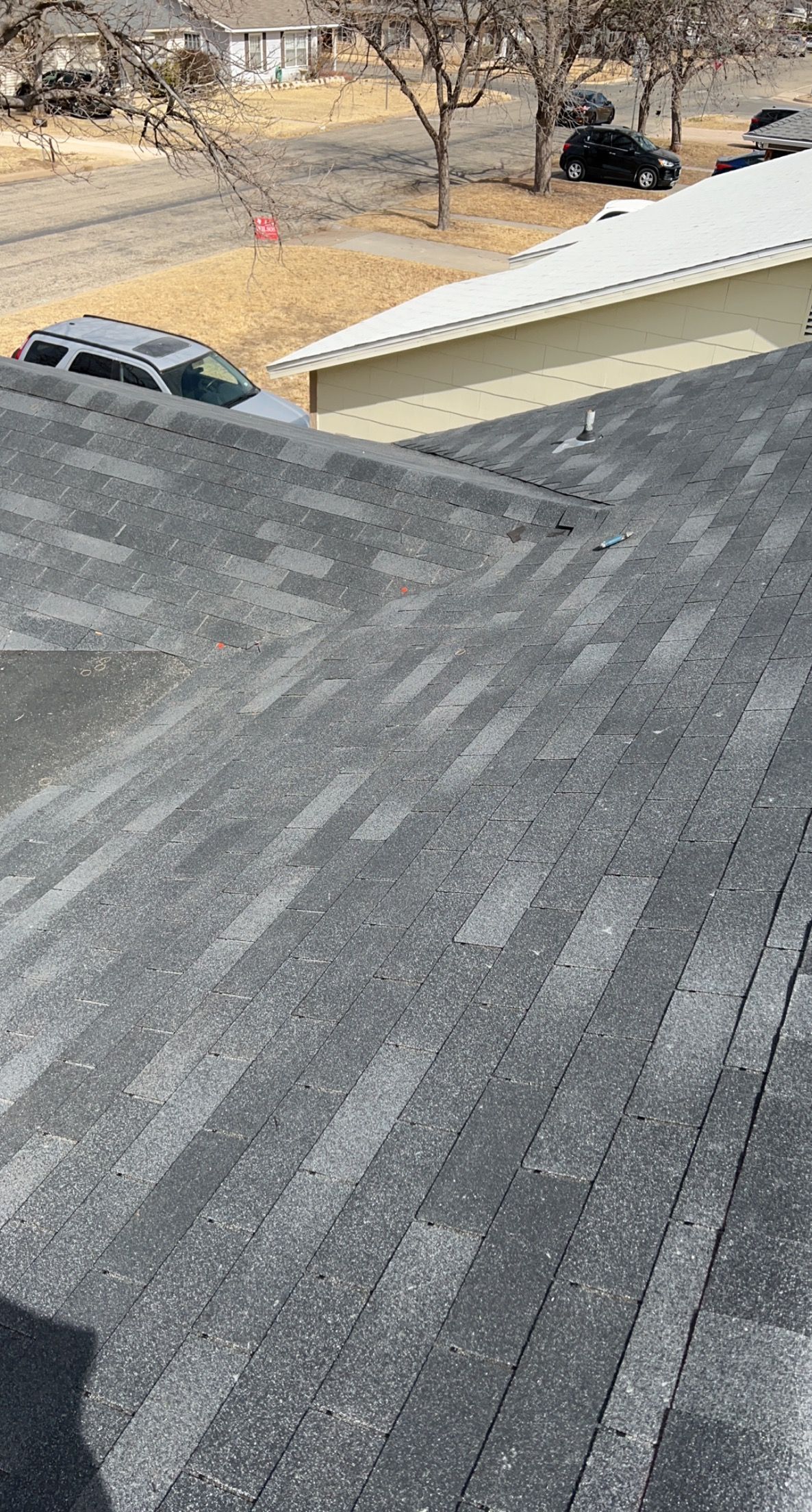 A close up of a roof with a car parked on it.
