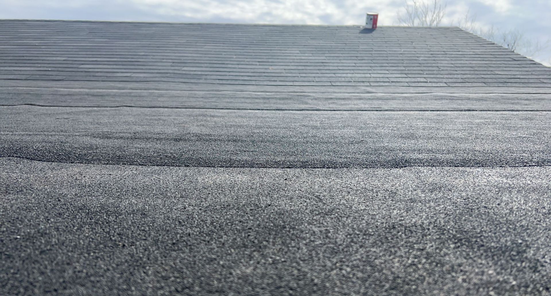A close up of a roof with a lot of snow on it.