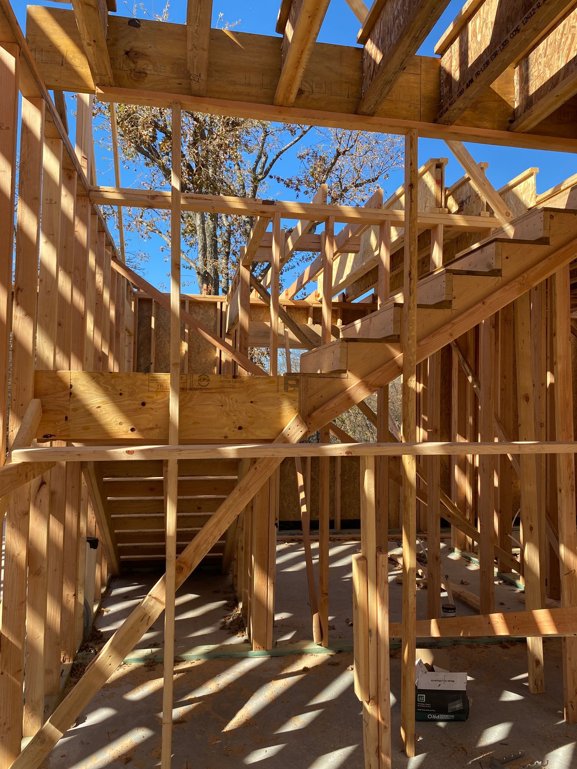 A house is being built with wooden beams and stairs.