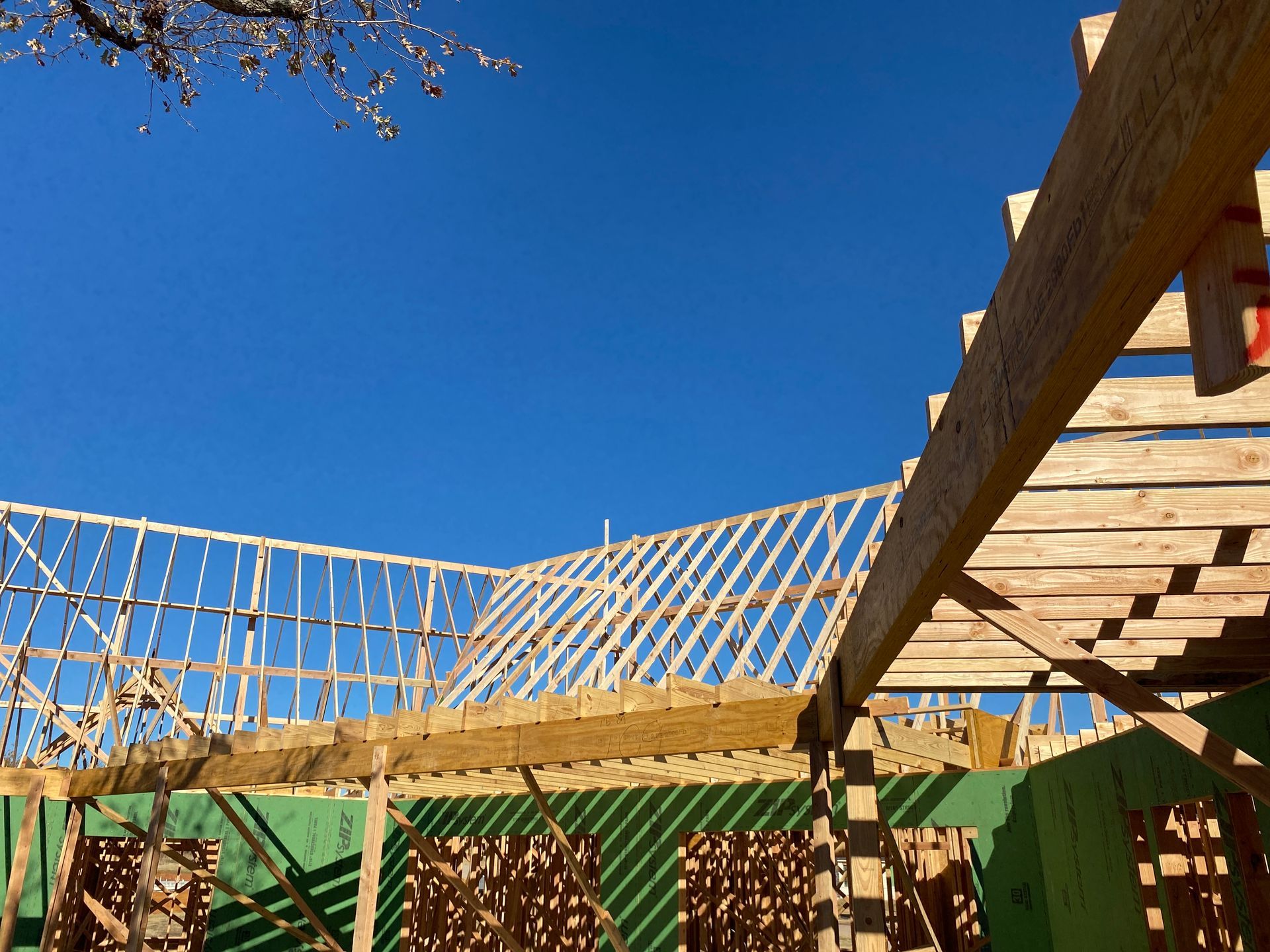 A building under construction with a blue sky in the background