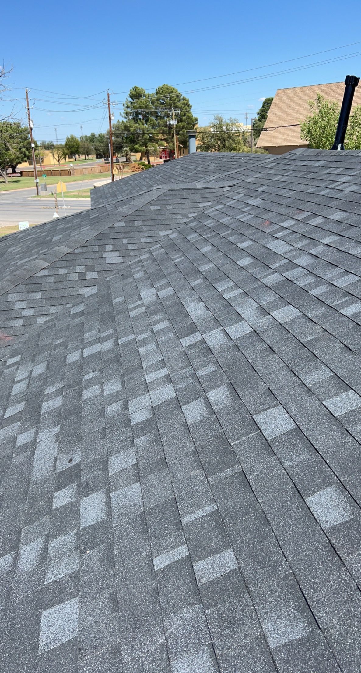 A close up of a roof with a blue sky in the background.