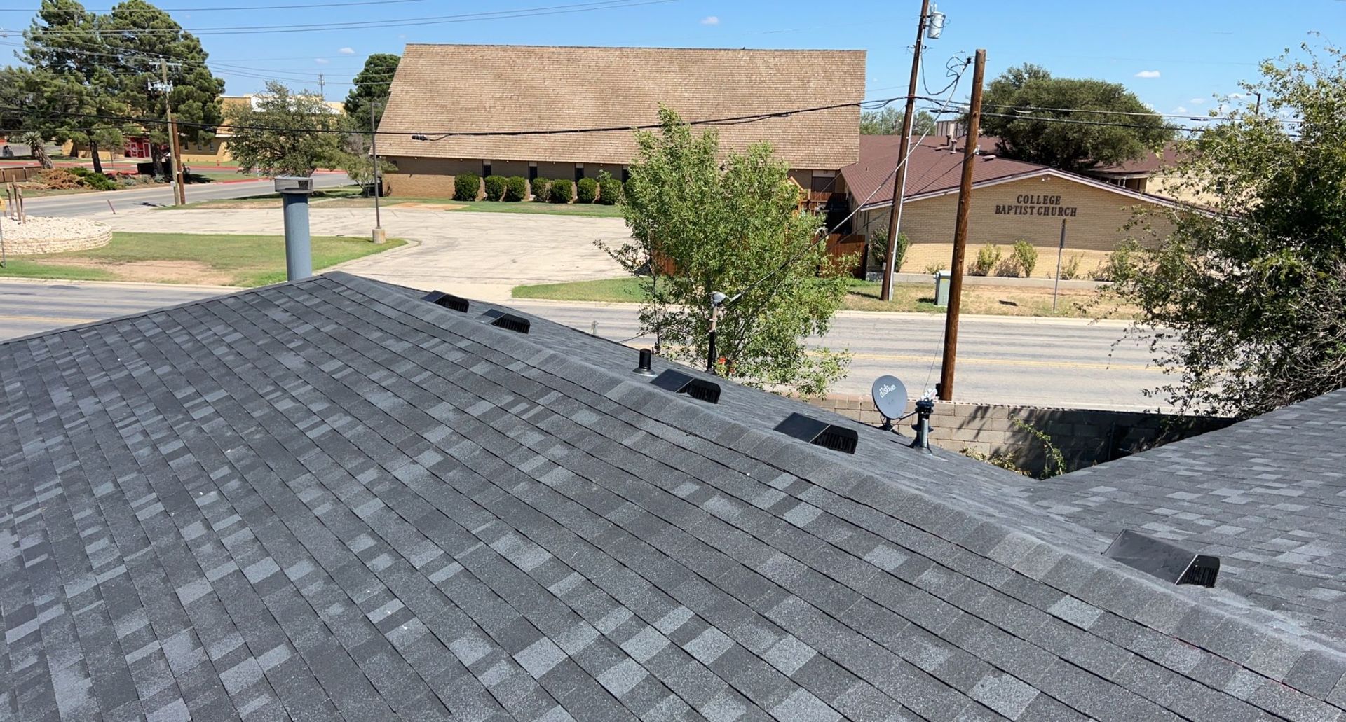 The roof of a house with a satellite dish on it.