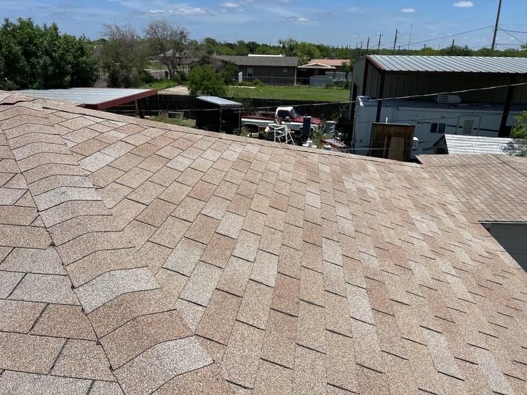 A close up of a roof with a lot of shingles on it.