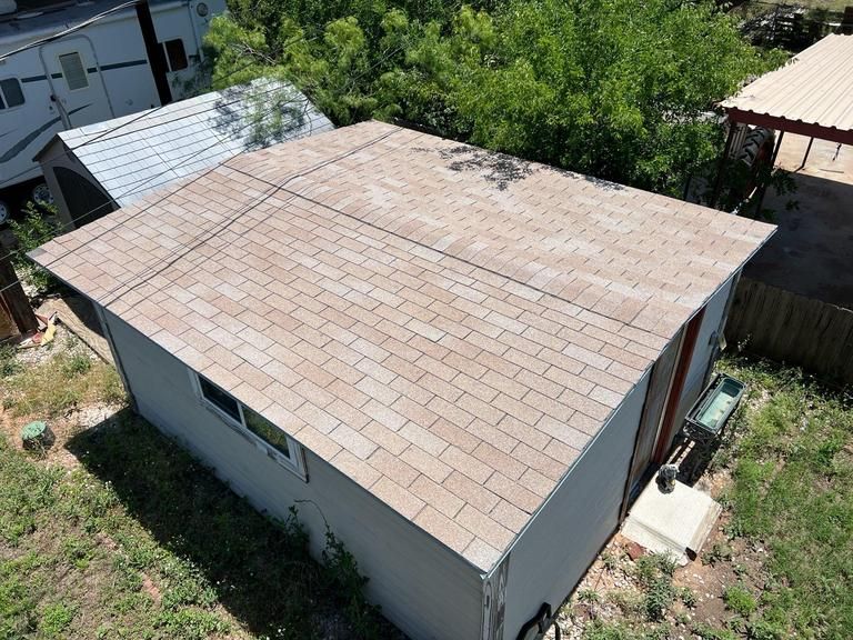 An aerial view of a house with a brown roof