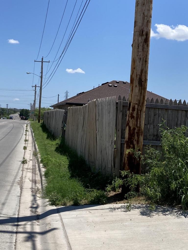 A wooden fence along the side of a road