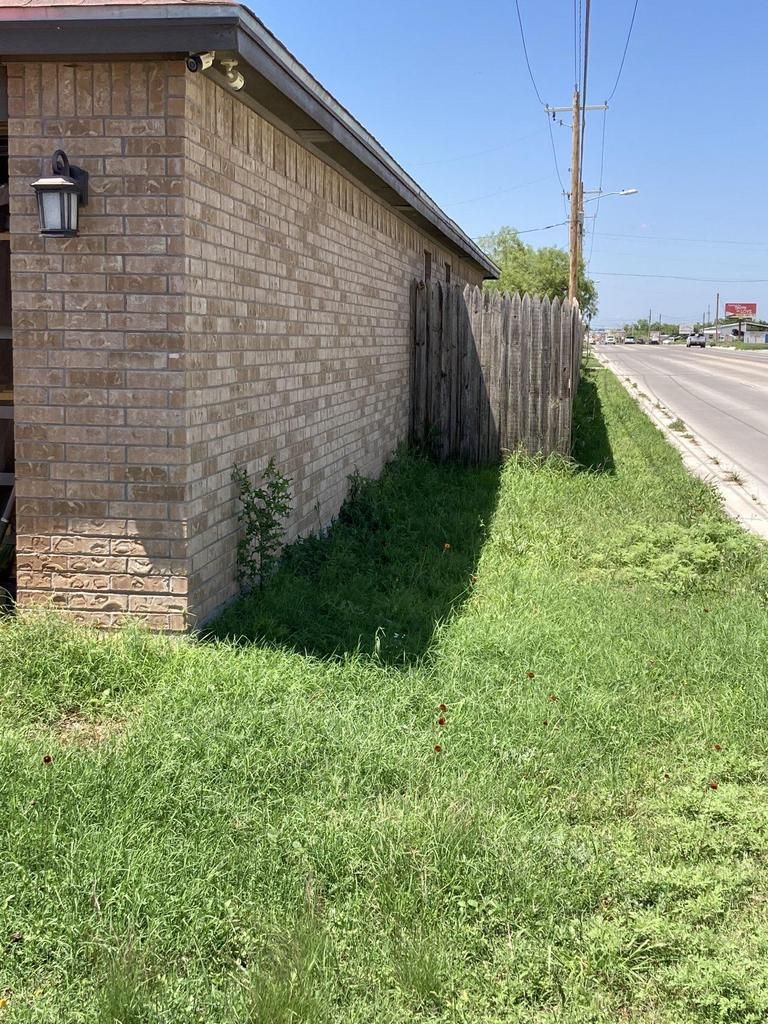 A brick building with a wooden fence in front of it.