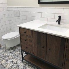 A bathroom with a sink , toilet , and mirror.