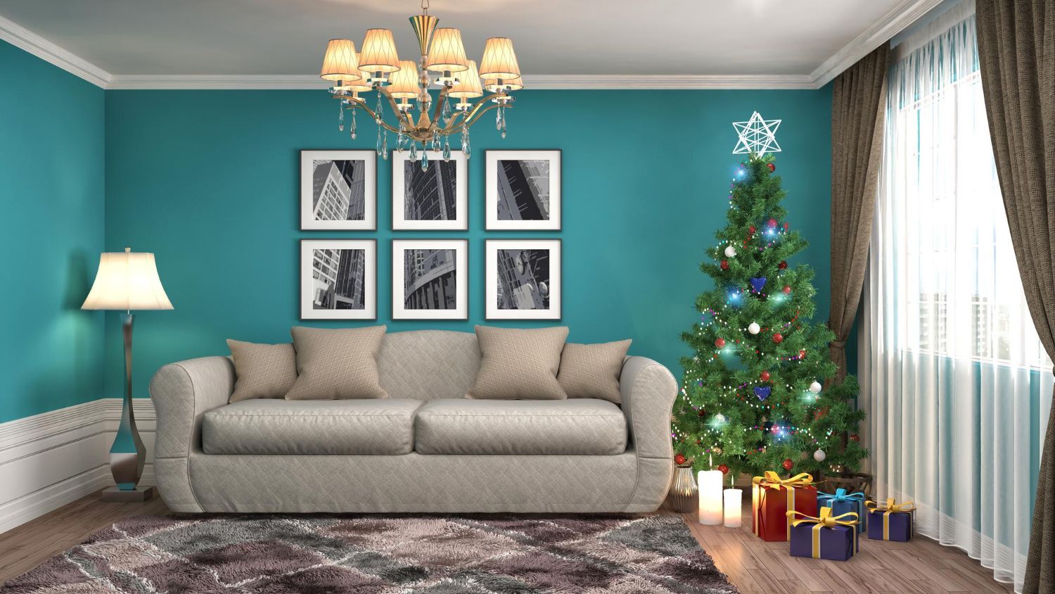 Christmas-decorated teal living room with a tree, presents, sofa, and a chandelier.
