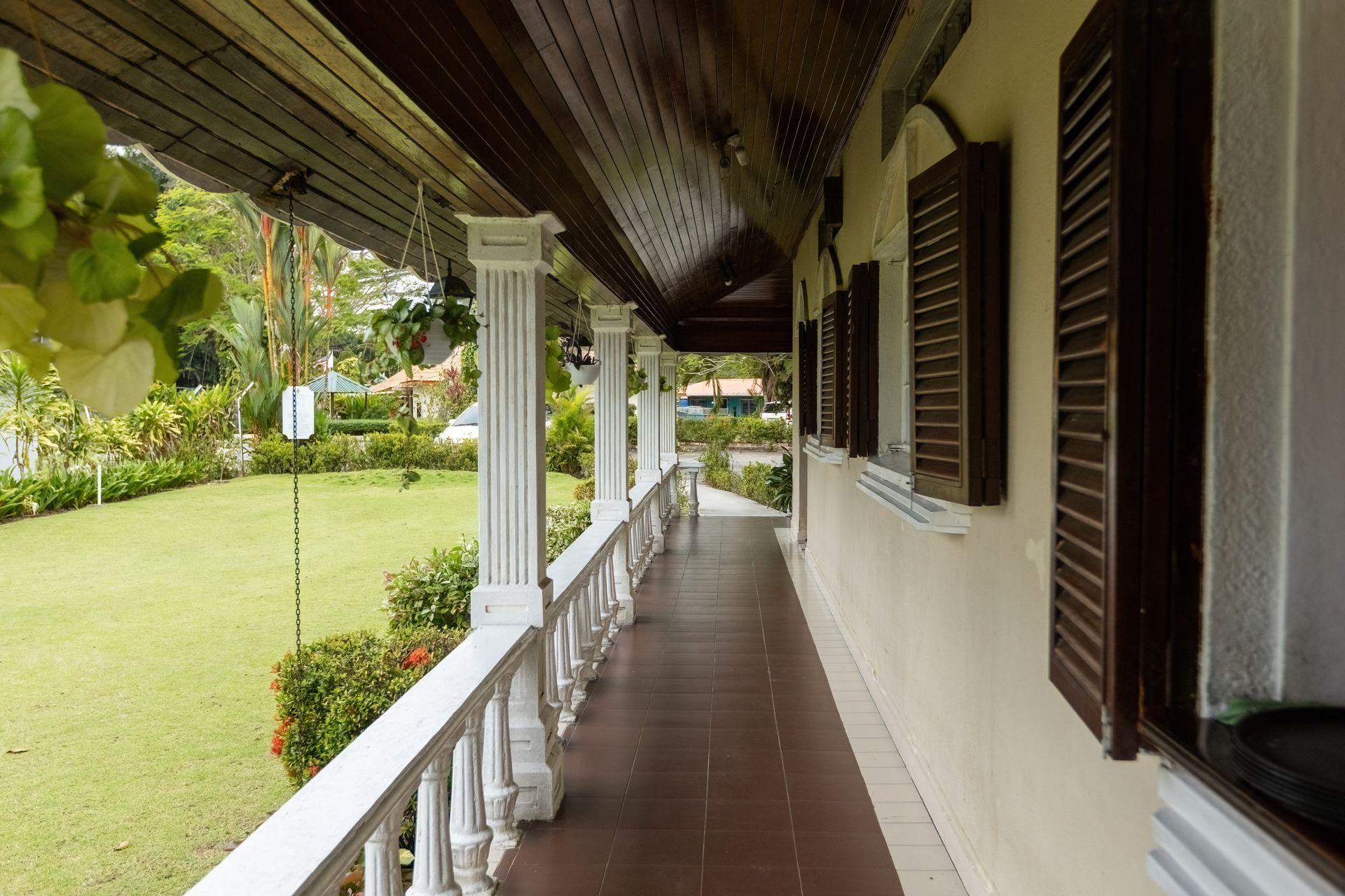 A long hallway leading to a lush green field