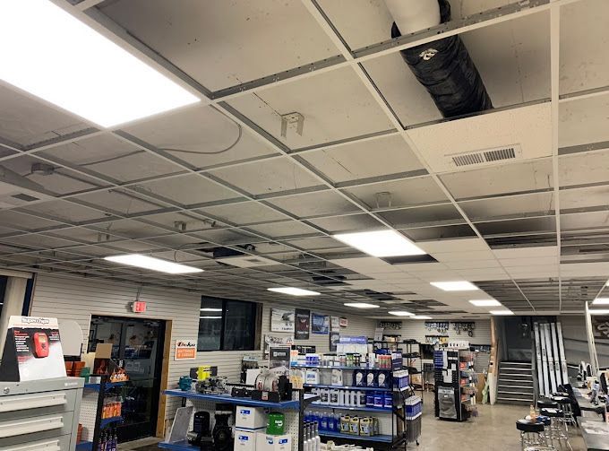 A large room with a ceiling that has been damaged in a store.