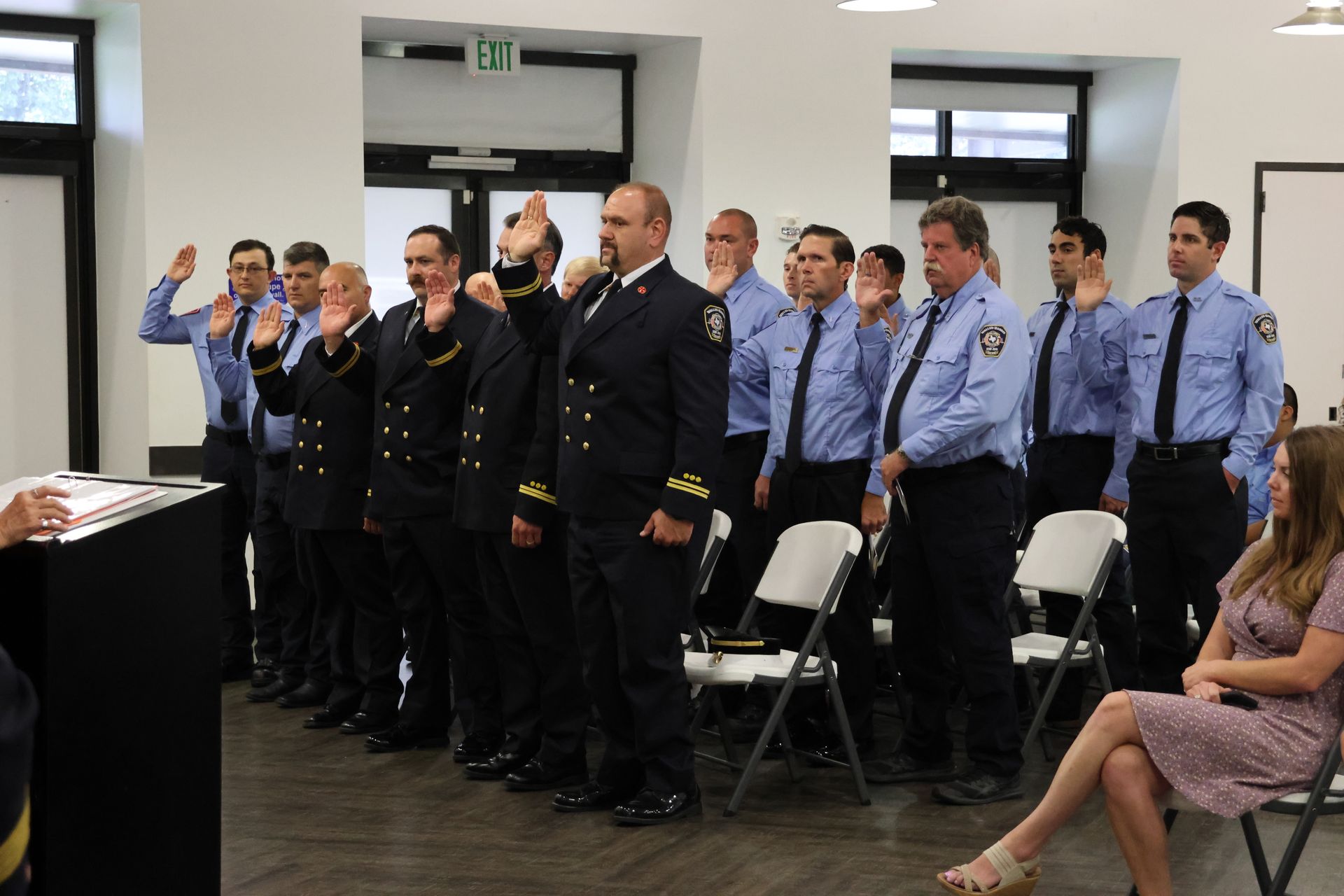 Photo of firefighters raising their right hand during the Oath of Office portion of the Badge Pinning Ceremony. 