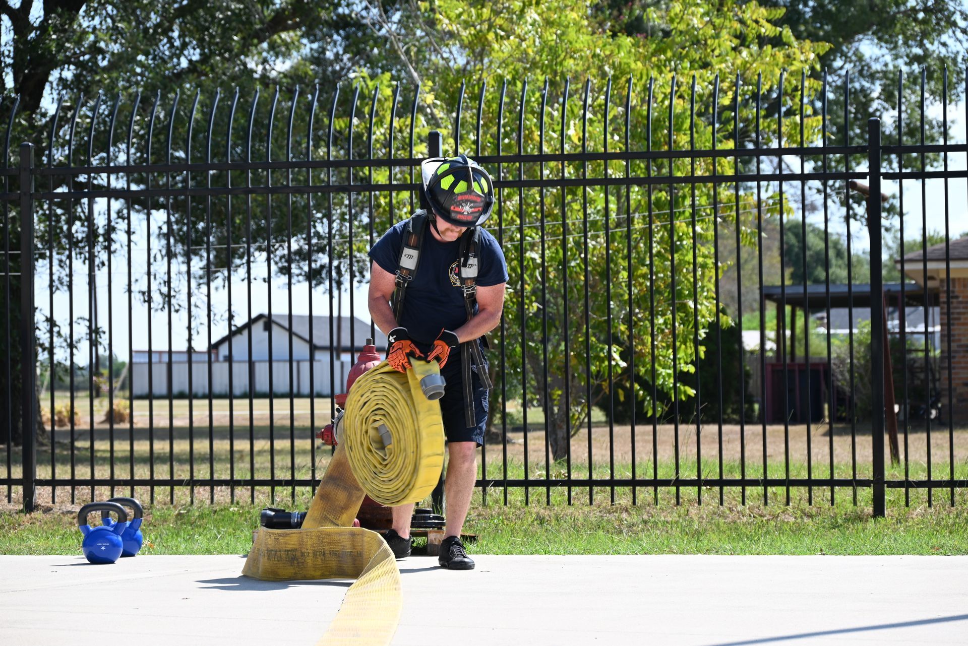 A firefighter is holding a fire hose.