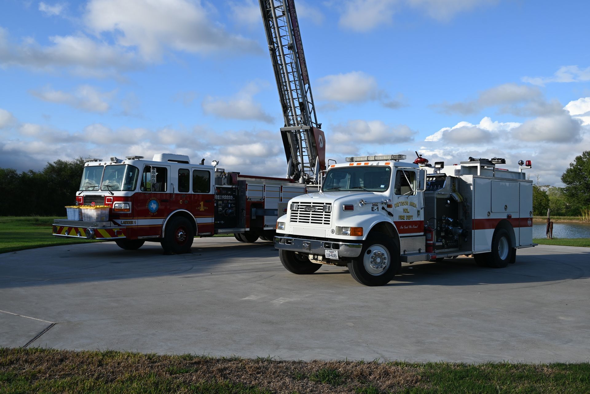 Two fire trucks are parked next to each other in a parking lot
