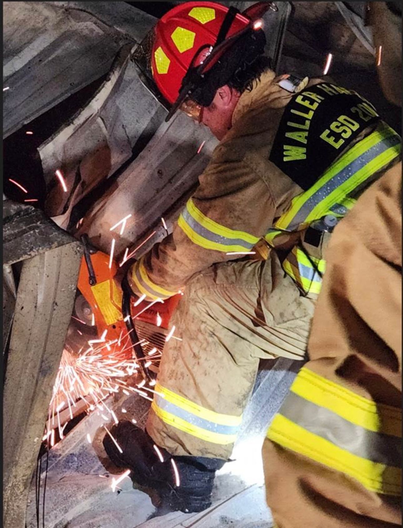 A Waller-Harris ESD 200 fire pumper truck is in front of a mobile home that is on fire with hoses leading to the fire.