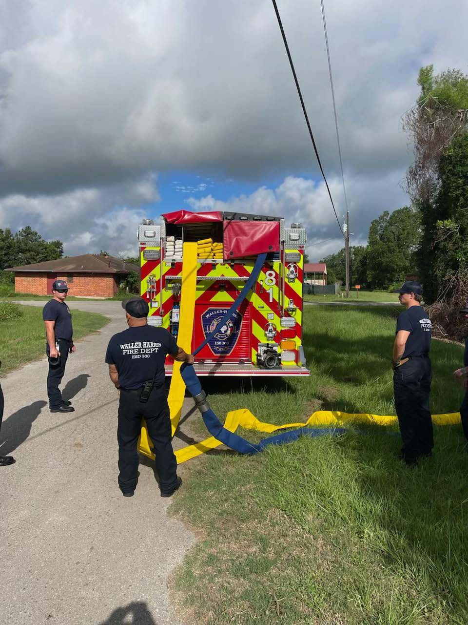 A group of firefighters standing next to a fire truck