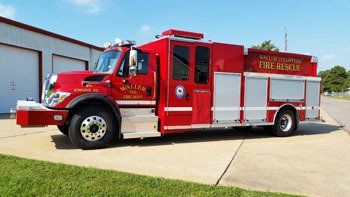 A red fire truck is parked on the side of the road.