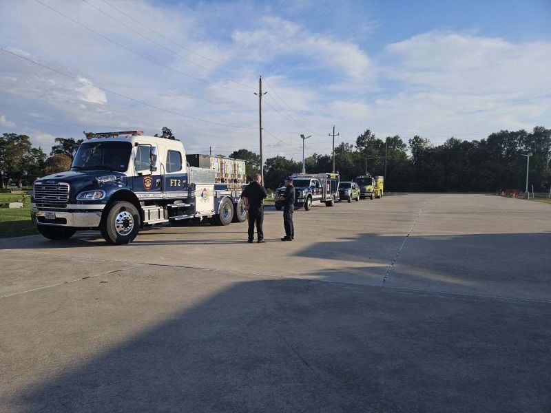 Harris County Hazmat emergency vehicles are parked in a parking lot