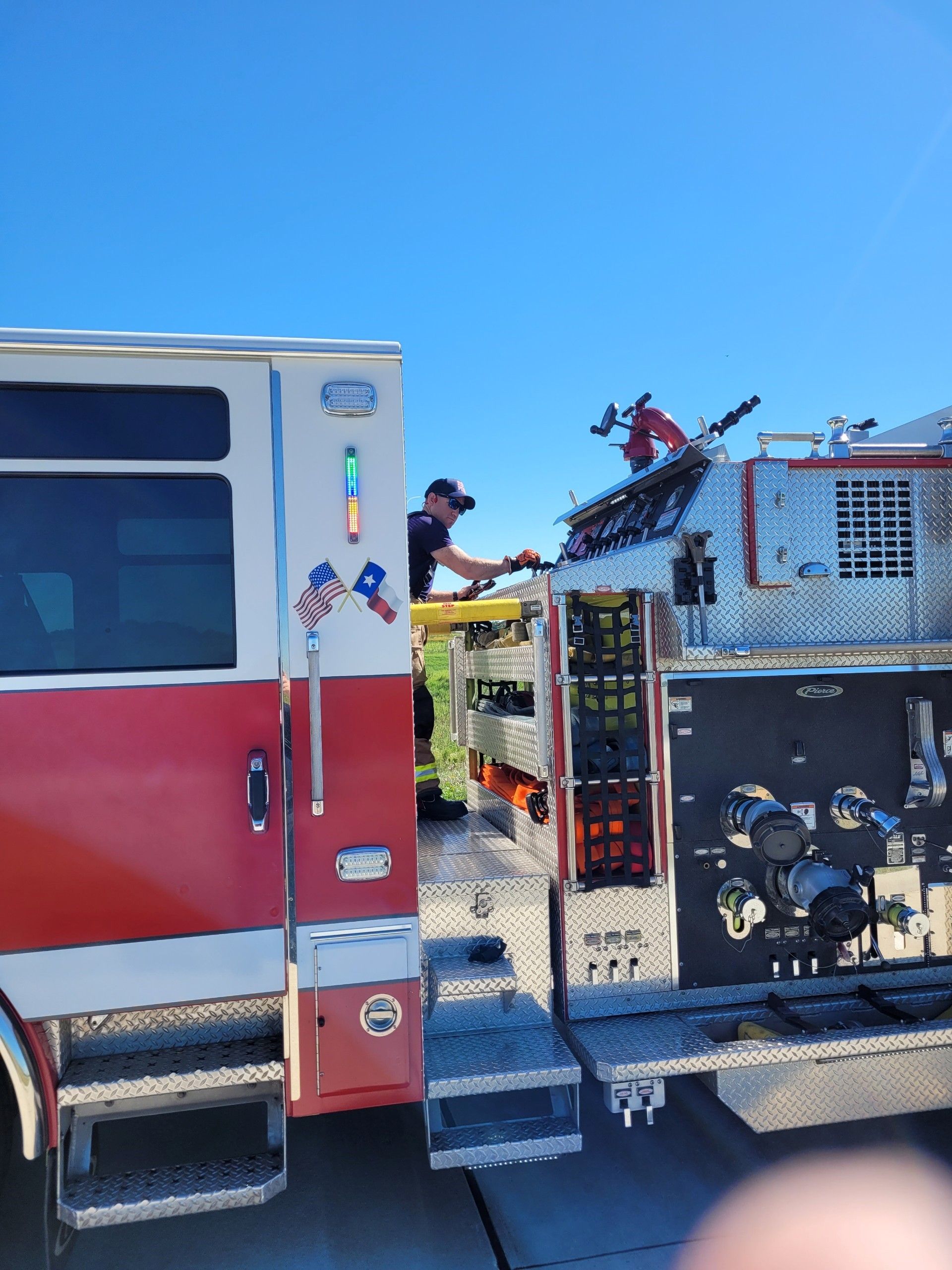 A fire fighter is standing at a panel with handles pumping water.