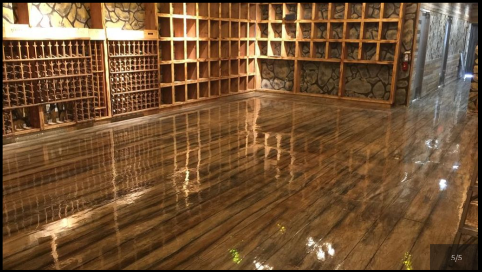 A large room with lots of shelves and a wooden floor