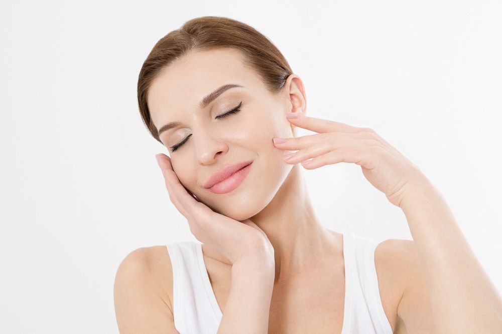 A Woman is showing her glowing skin with Her Hands — Palm Beach Currumbin Injectables in Currumbin, QLD
