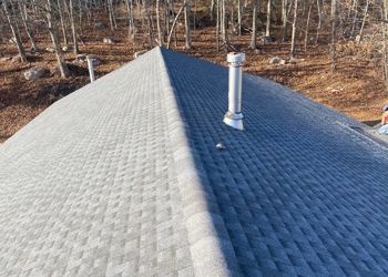 An aerial view of a roof with a chimney on top of it.