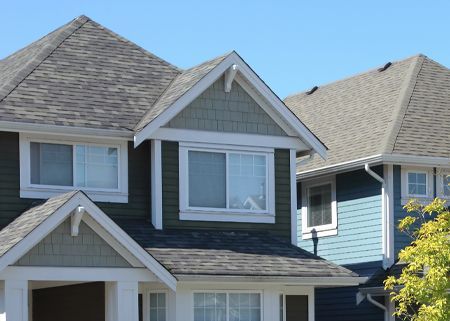 A blue and white house with a gray roof