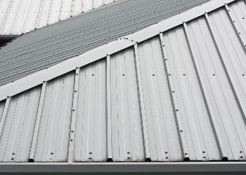 A close up of a white metal roof on a building.