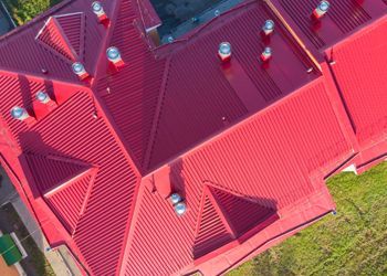 An aerial view of a red roof of a building.