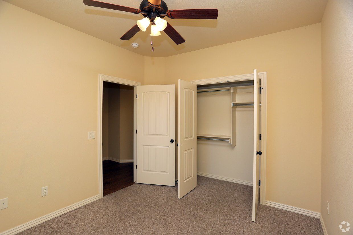 Bedroom with fan and closet