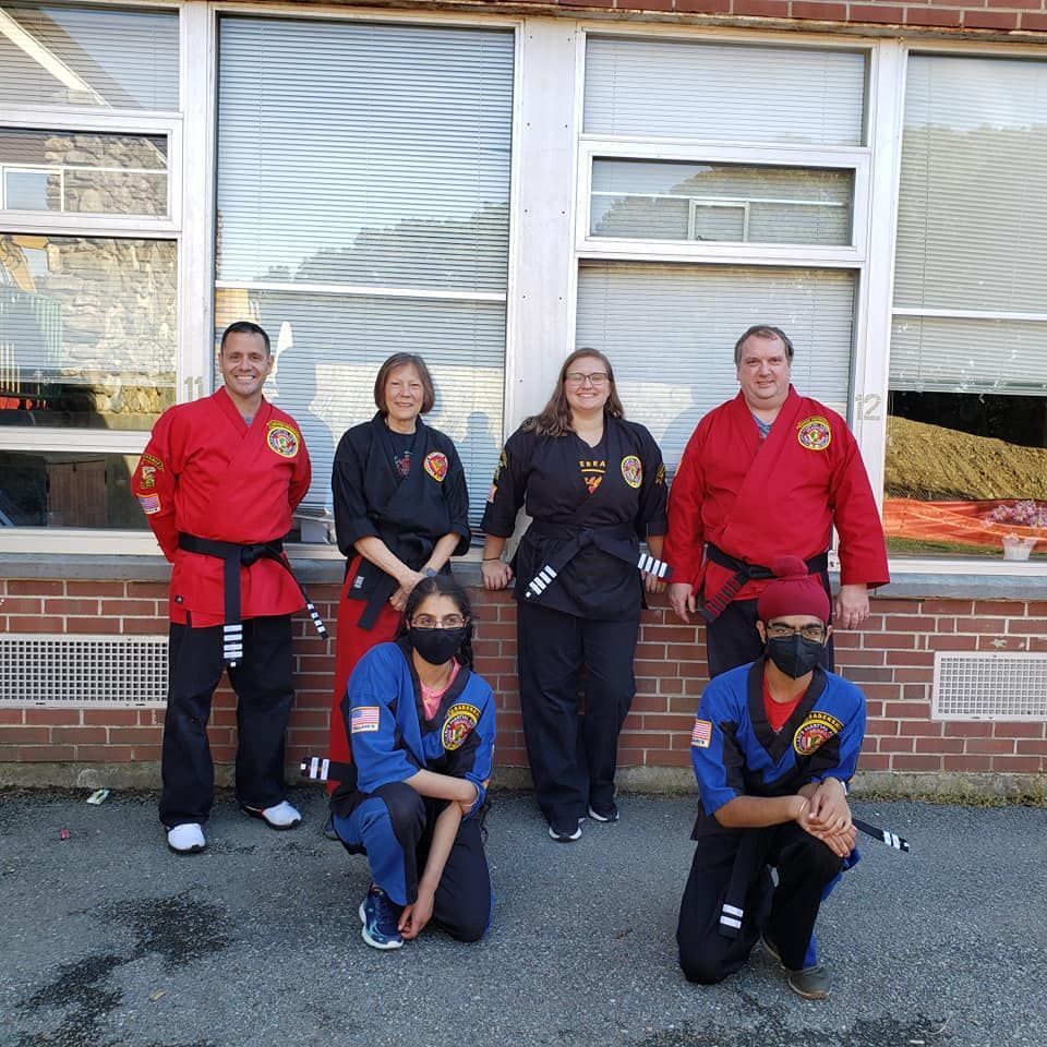 a group of people are practicing martial arts in a gym .