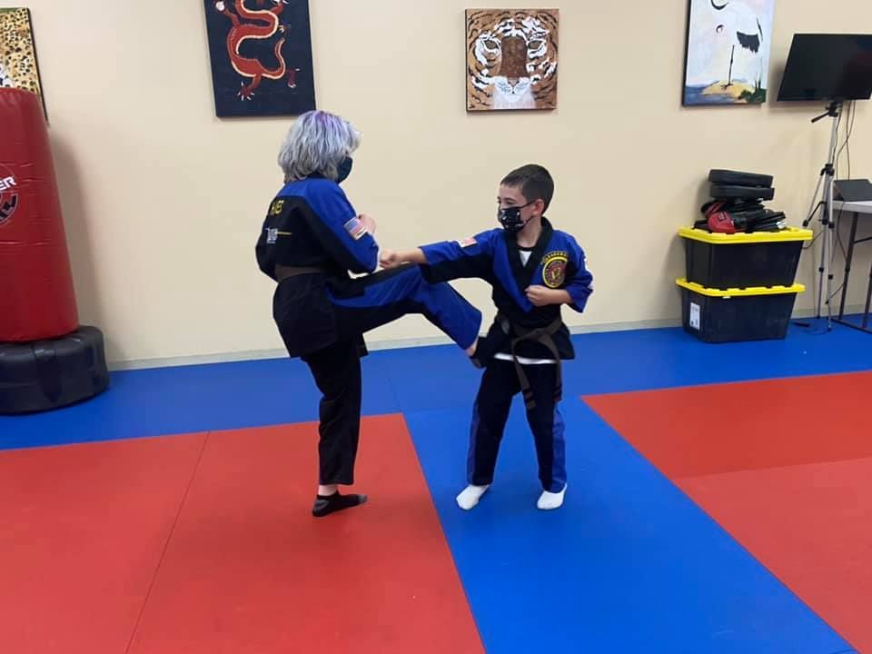 a man and a girl are posing for a picture in front of a newspaper that says the ryukyu news