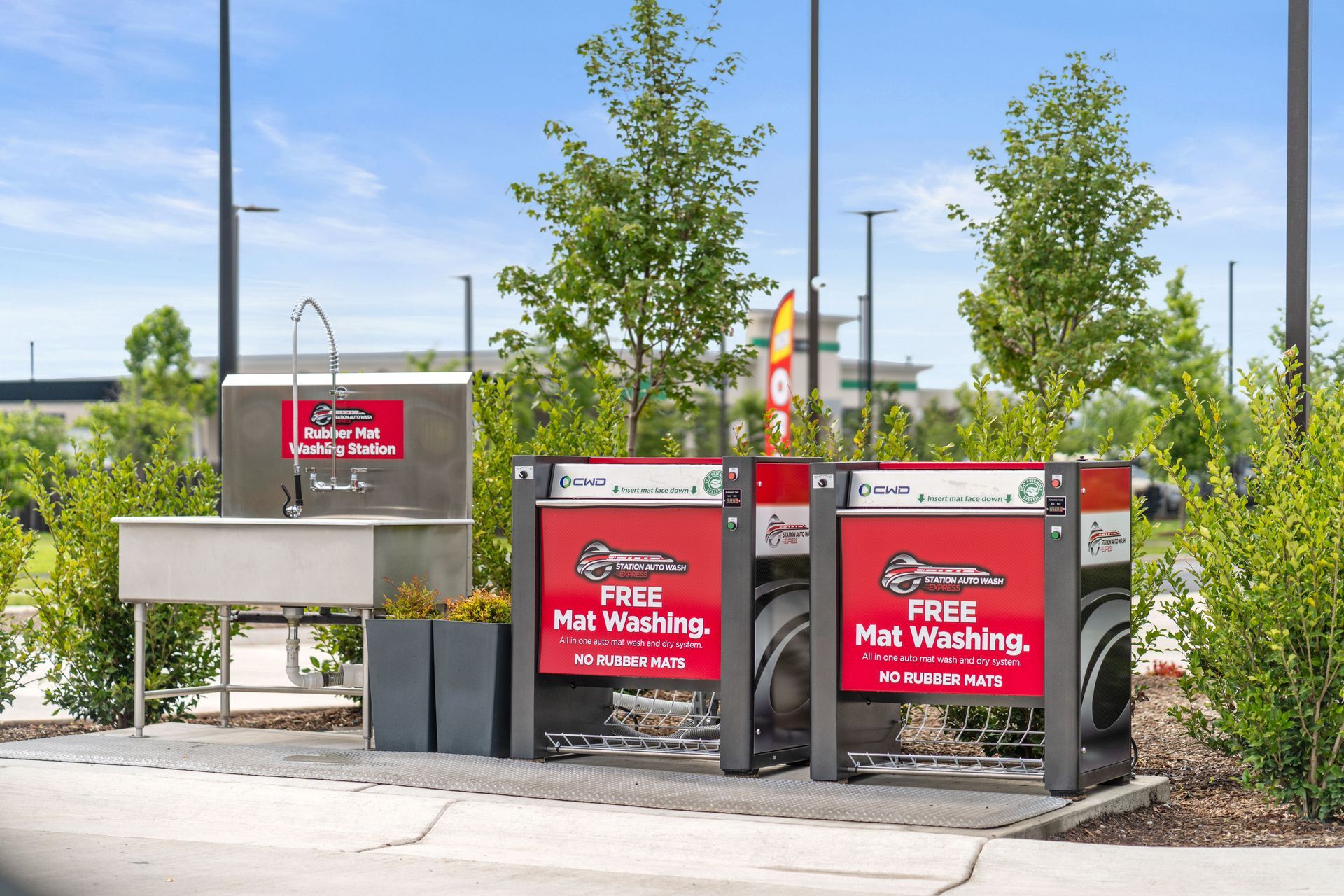 Outdoor free car wash mat cleaning station with sink and soap dispenser.