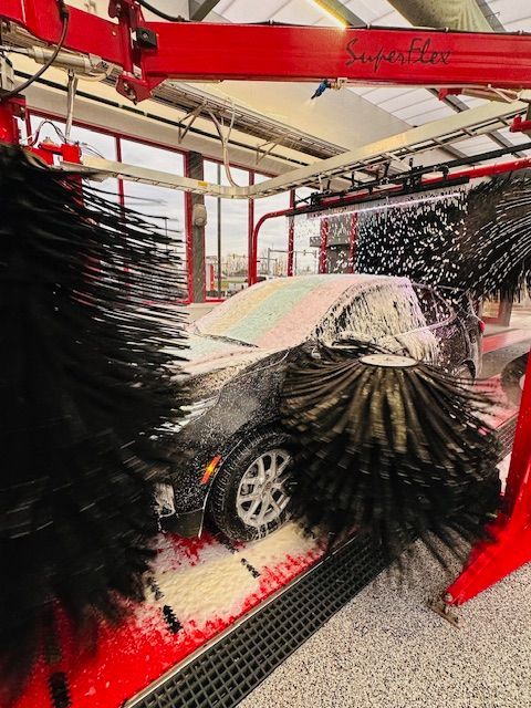 A car is being washed in a car wash.
