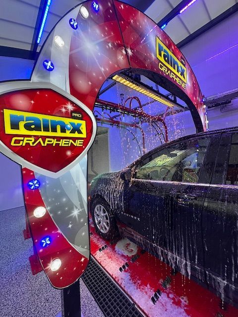 A car is being washed in a rainx graphene car wash