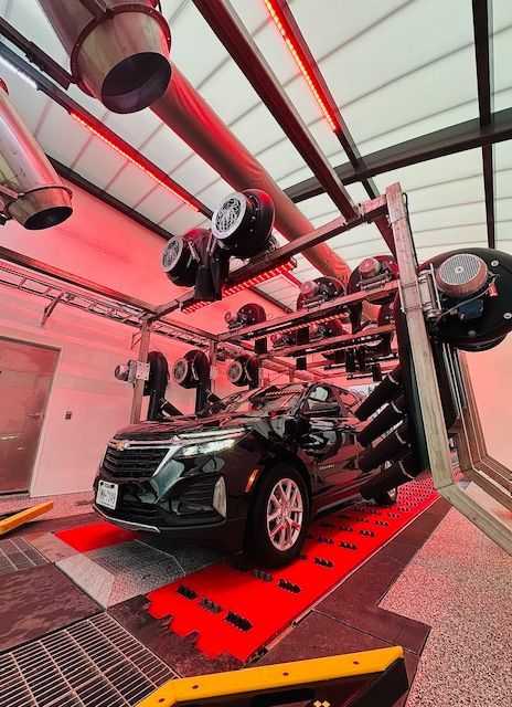 A car is sitting on a ramp in a car wash