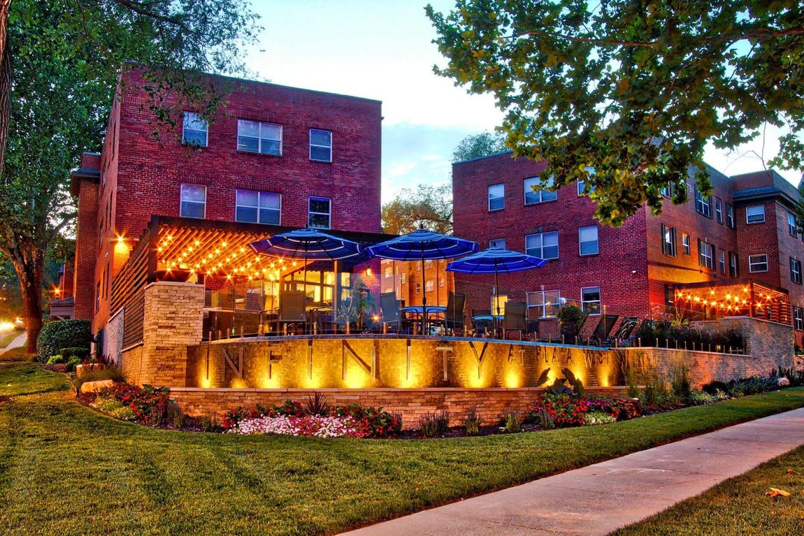 A large brick building with umbrellas in front of it