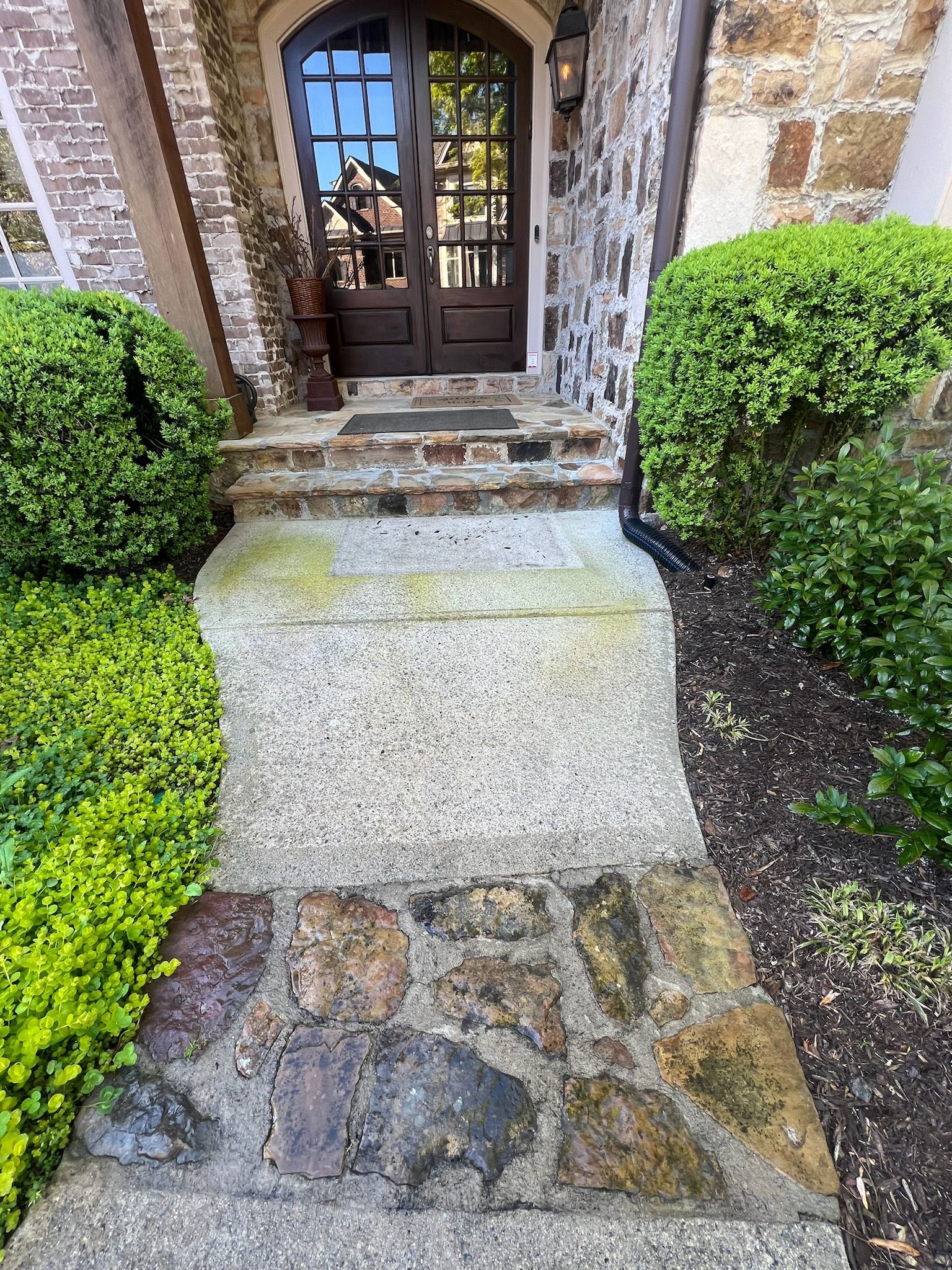 A stone walkway leading to the front door of a house.