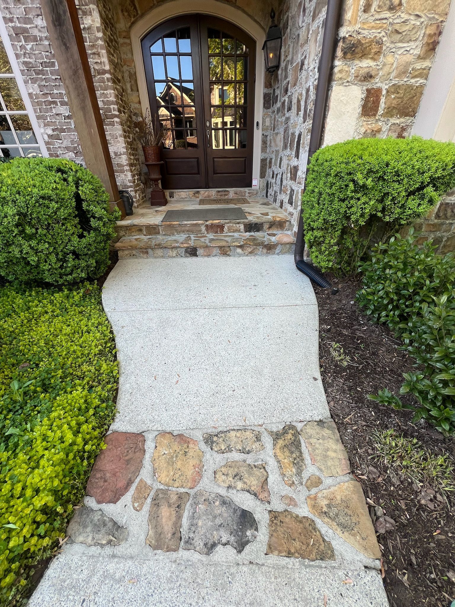 A stone walkway leading to the front door of a house.