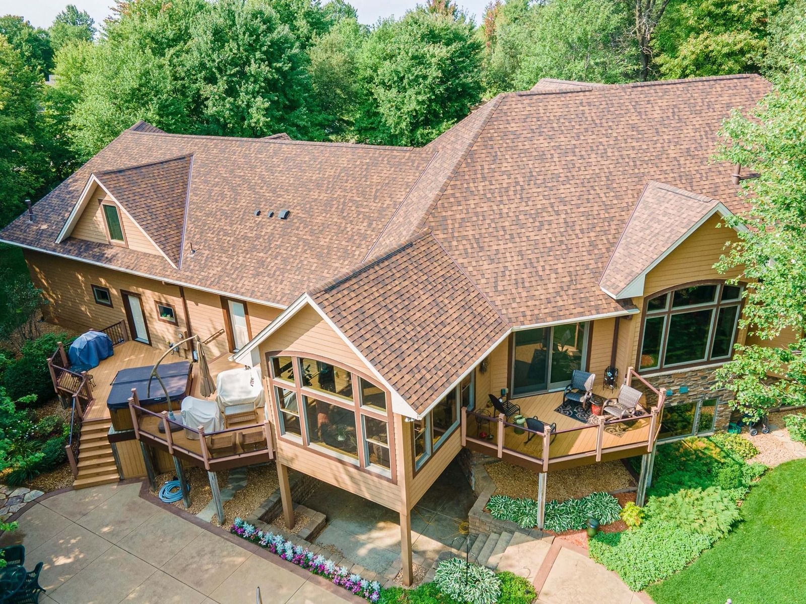 A man wearing a hard hat and goggles is standing in a room.
