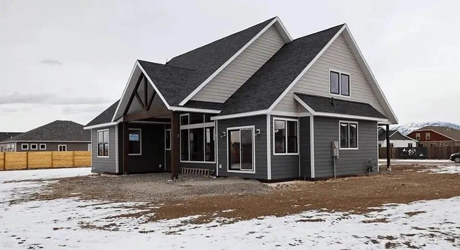 A man is working on a kitchen in a house under construction