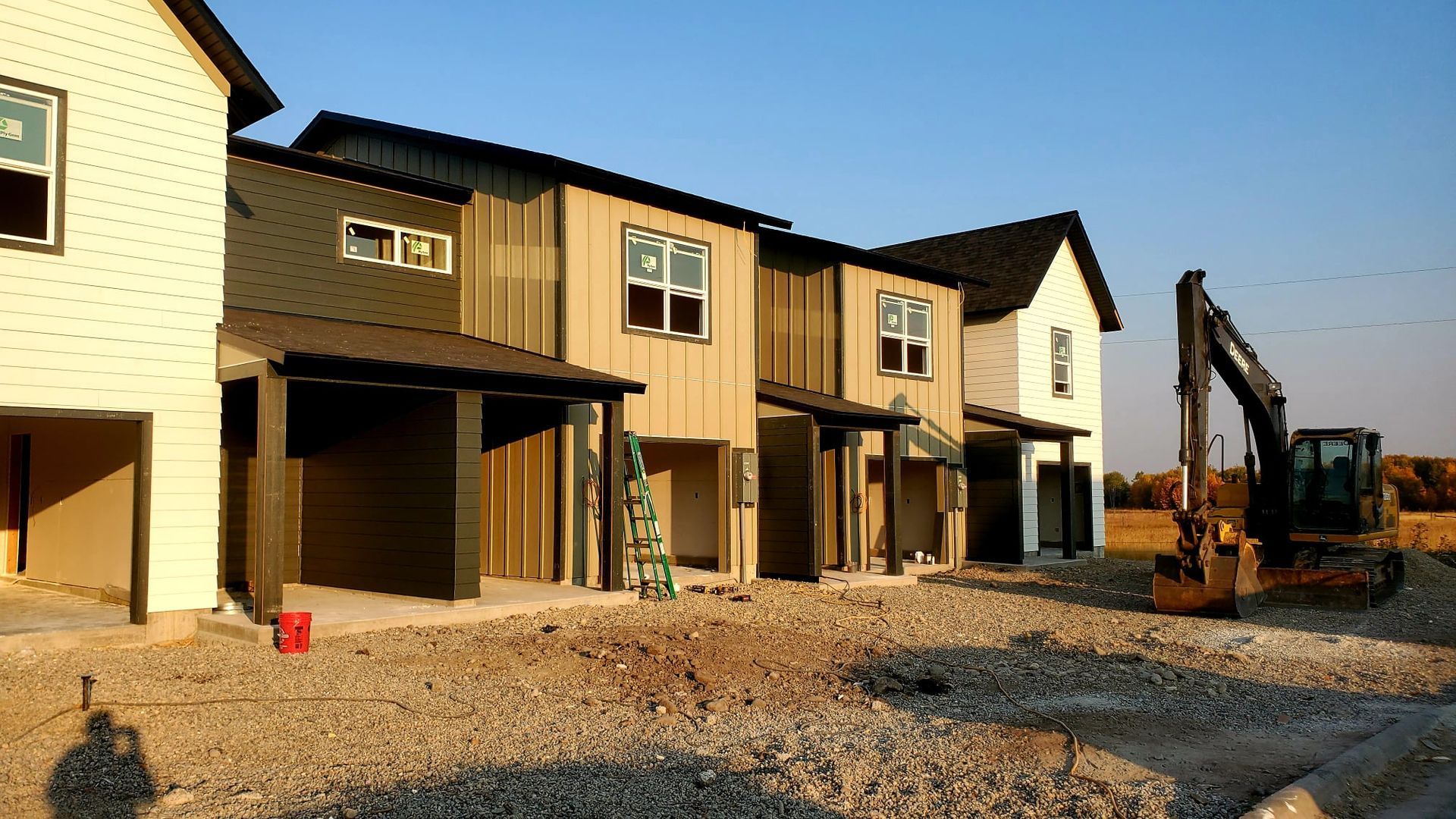 Two men are standing in an empty room with black walls