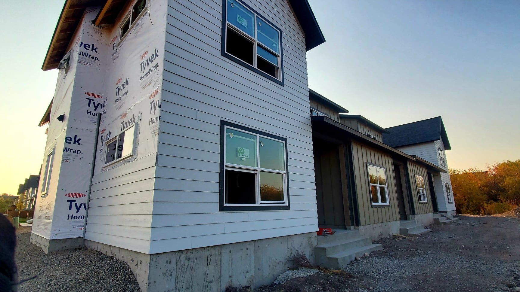 New multi-unit residential construction. Exterior siding and windows installed, awaiting finishing touches.
