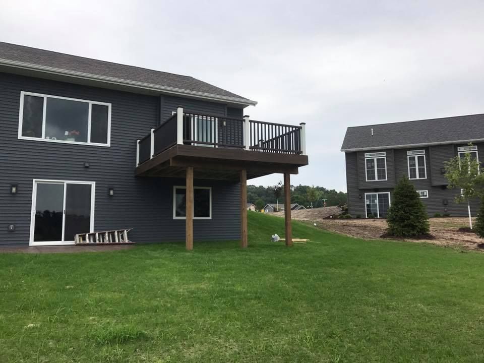 A man wearing a hard hat and goggles is standing in a room.