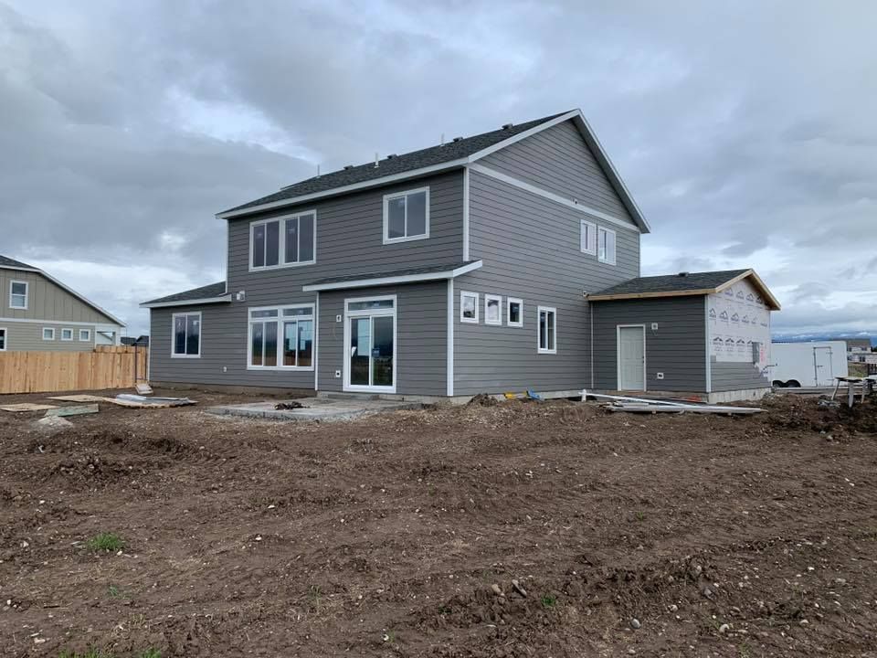 A man wearing a hard hat and goggles is standing in a room.
