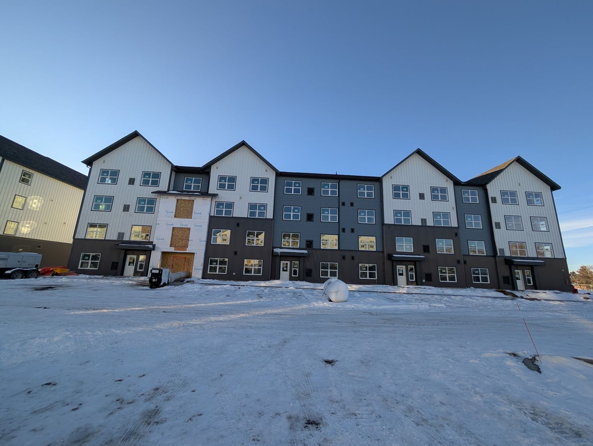 A building under construction with a red roof